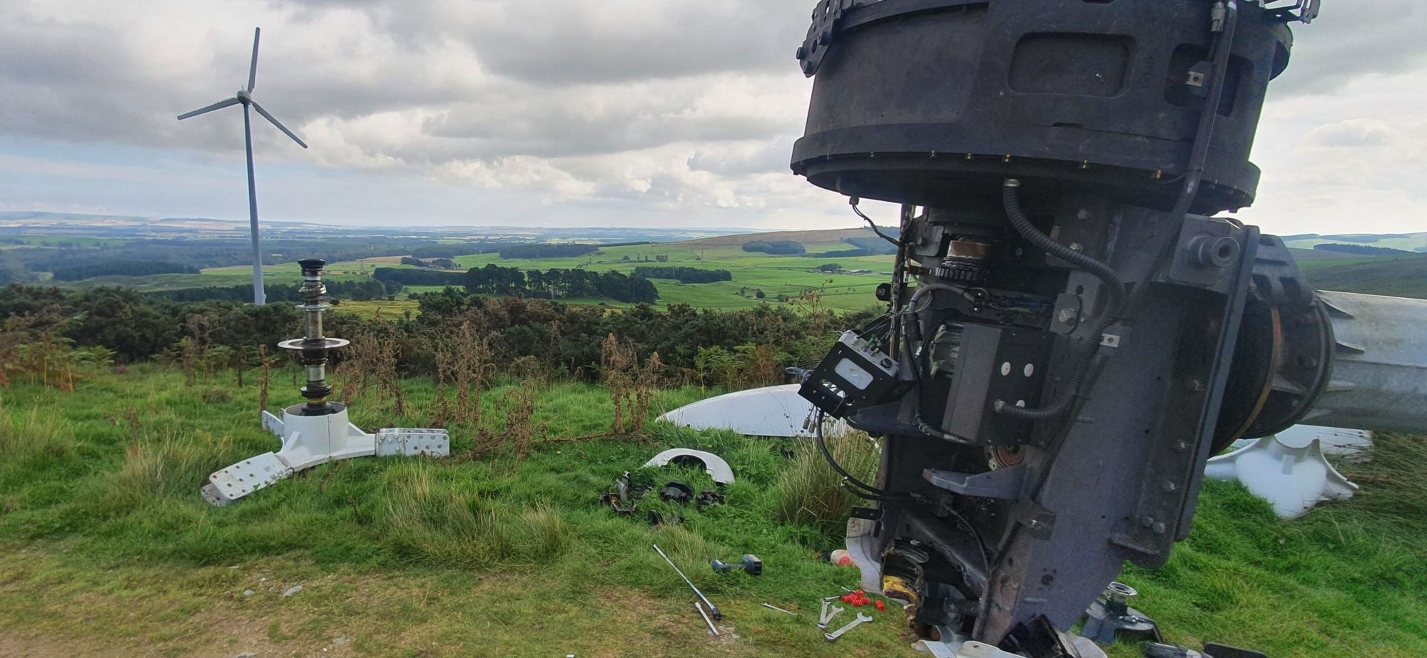 A wind turbine nacelle stripped down on site for repair